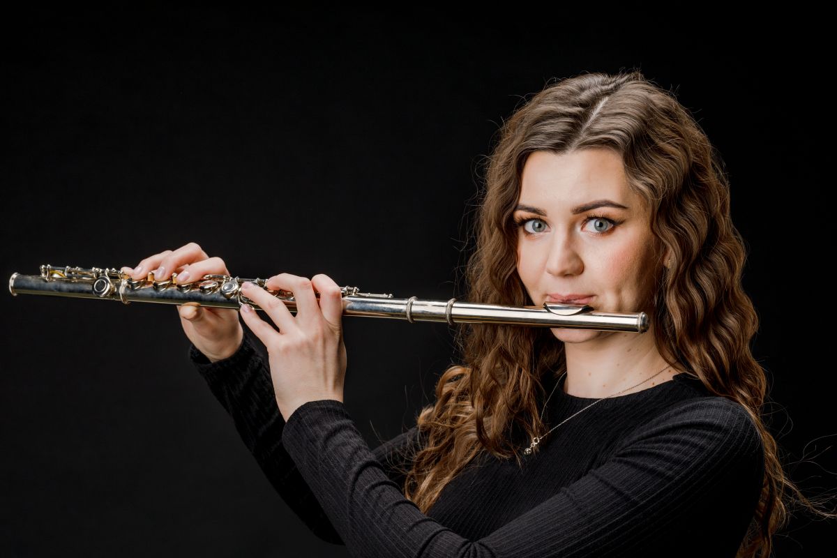 Teenager learning the Flute with a teacher